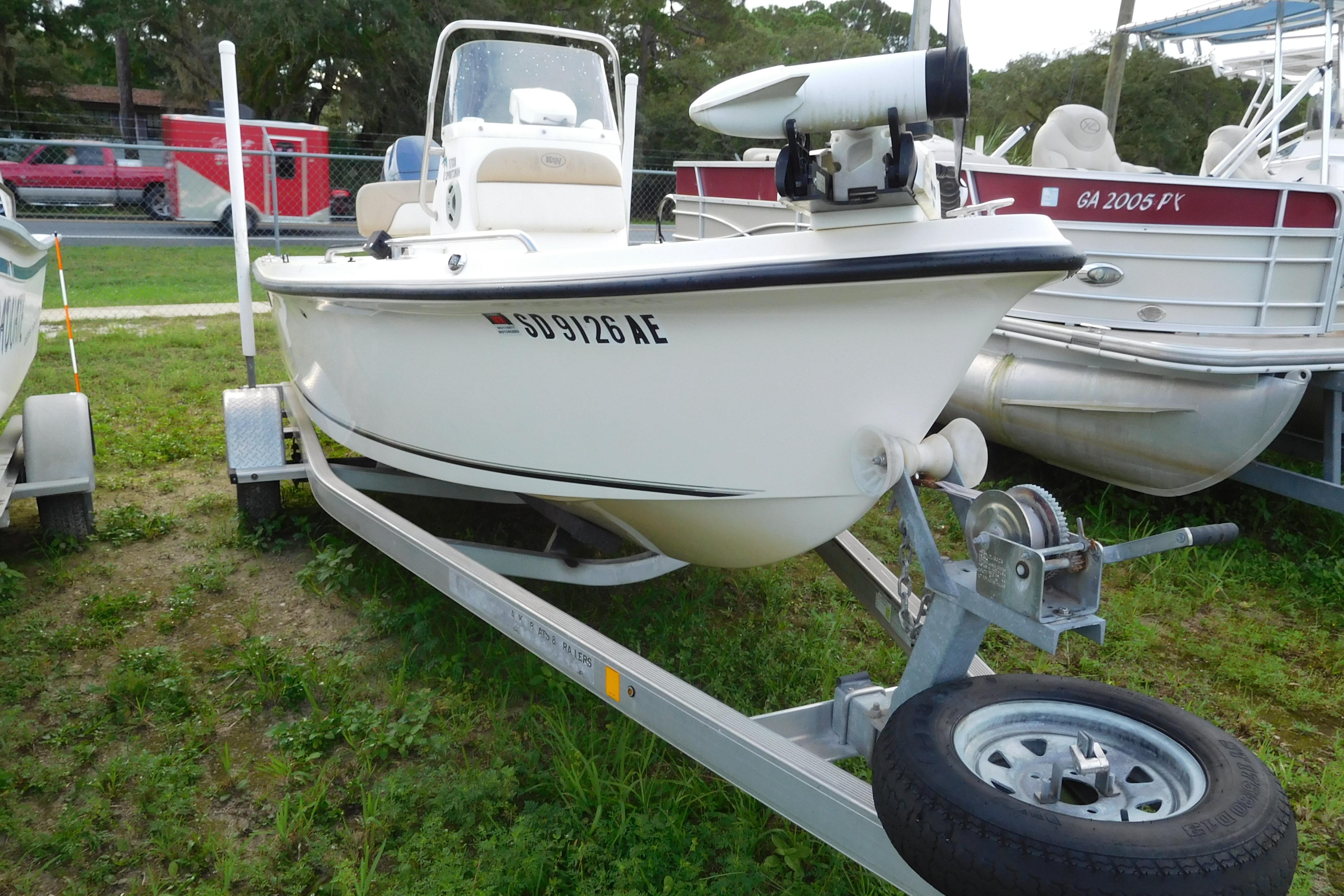 Key West 1720 Center Console 2015 Key West 1720 Center Console boat on trailer, parked on grass.