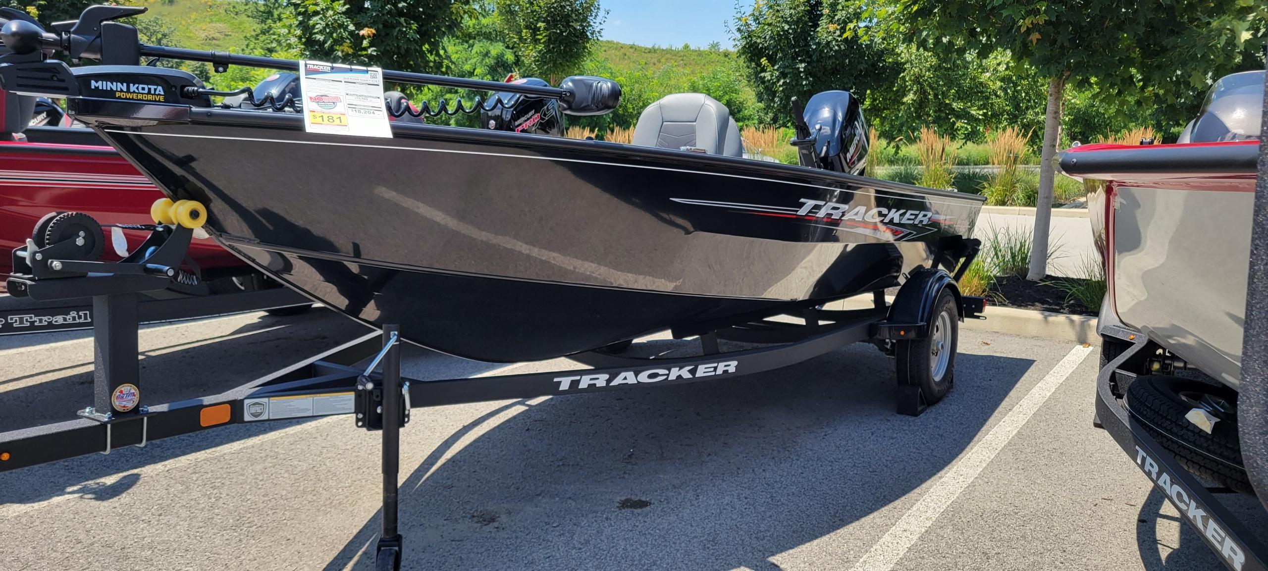 Tracker Super Guide V-16 T 2025 Tracker Super Guide V-16 T boat on trailer in parking lot.
