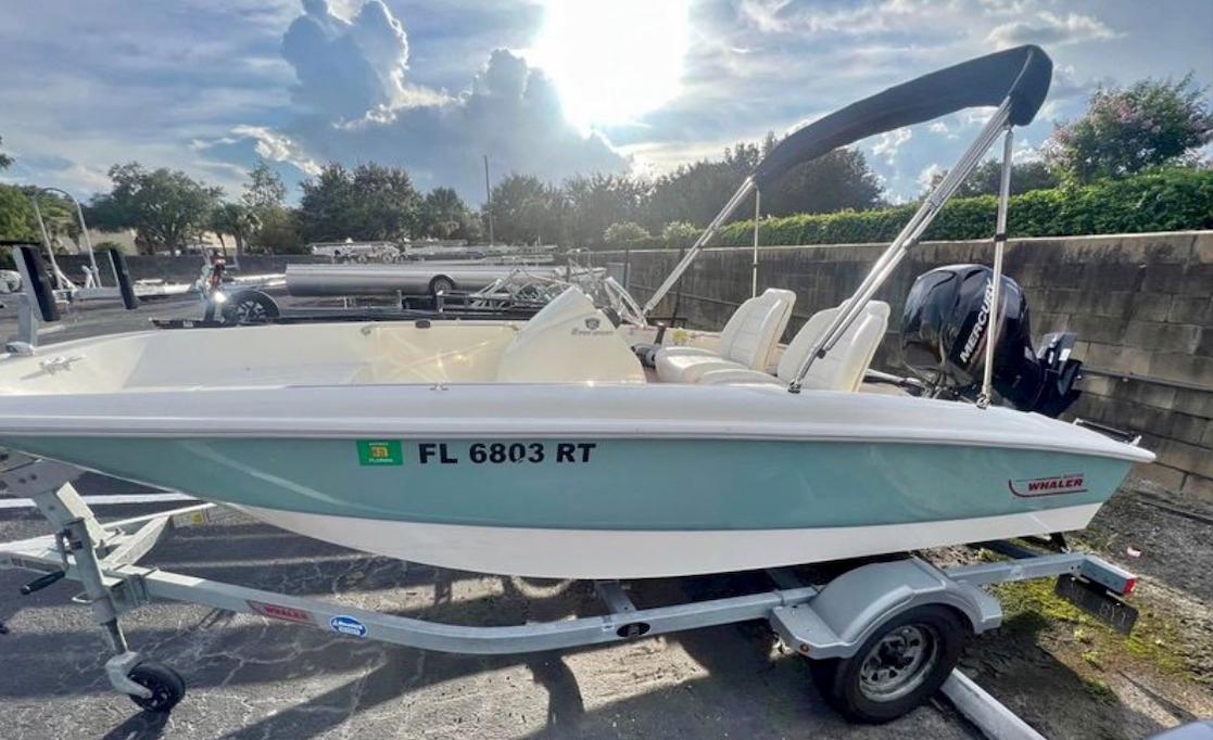 Boston Whaler 150 Super Sport 2018 Boston Whaler 150 Super Sport boat on trailer, parked outdoors under cloudy sky.