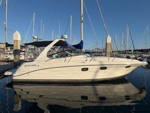 Four Winns 328 Vista 1999 Four Winns 328 Vista boat docked at marina, surrounded by sailboats.