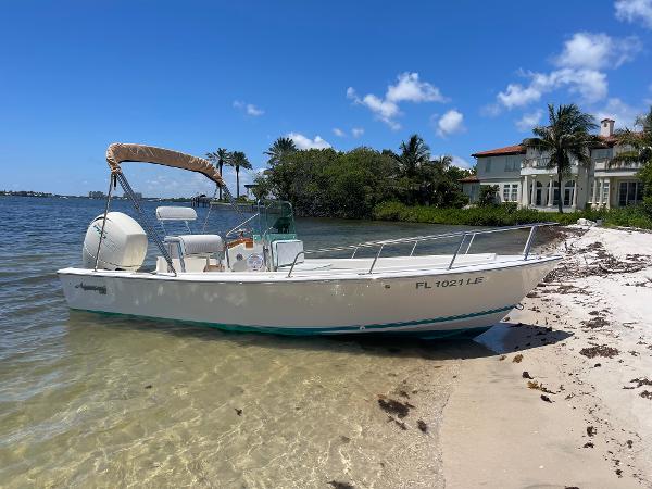 Aquasport 17 CC 1984 Aquasport 17 CC boat on sandy beach with clear blue sky.