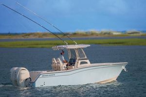 Grady-White Canyon 271 2026 Grady-White Canyon 271 boat cruising on a serene waterway.