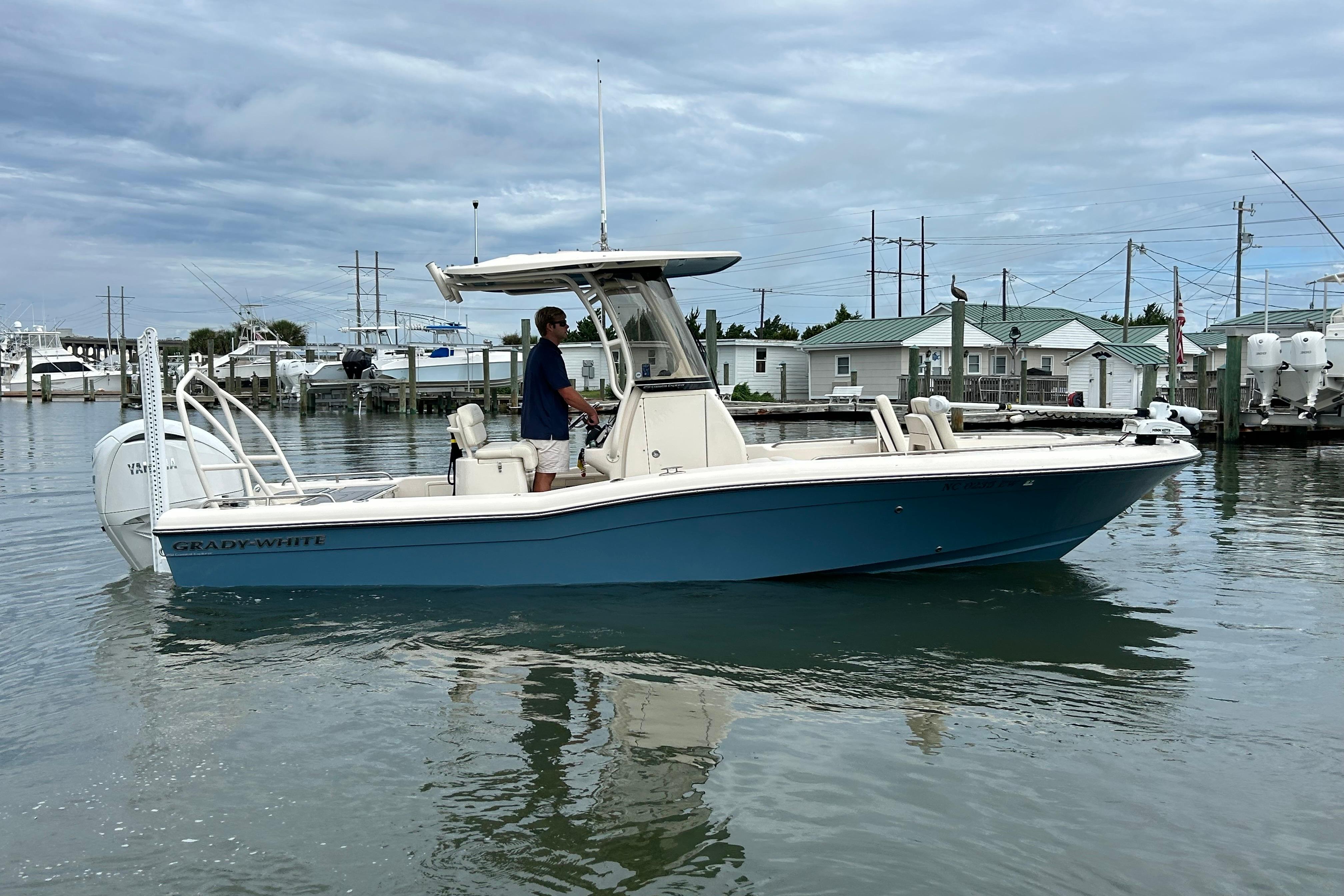 Grady-White 251 Coastal Explorer 2022 Grady-White 251 Coastal Explorer boat on calm water, dockside view.