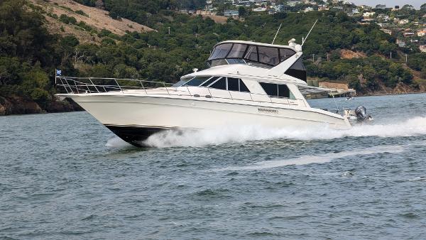 Sea Ray 550 Sedan Bridge 1997 Sea Ray 550 Sedan Bridge cruising on a scenic waterway.