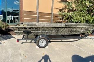 Tracker Grizzly 1754 Utility 2026 Tracker Grizzly 1754 Utility boat on trailer, outdoors, sunny day.
