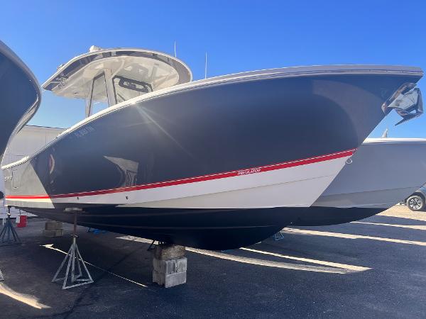 Regulator 31 2020 Regulator 31 boat with sleek design, dark hull, and red accent stripe.
