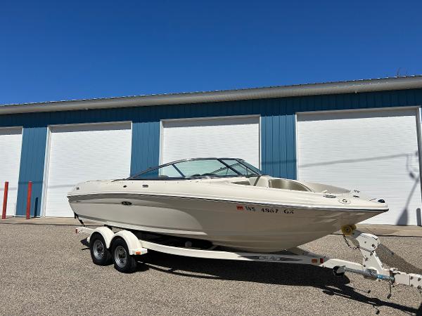Sea Ray 200 Sport 2005 Sea Ray 200SP boat on trailer, parked outside blue storage facility.