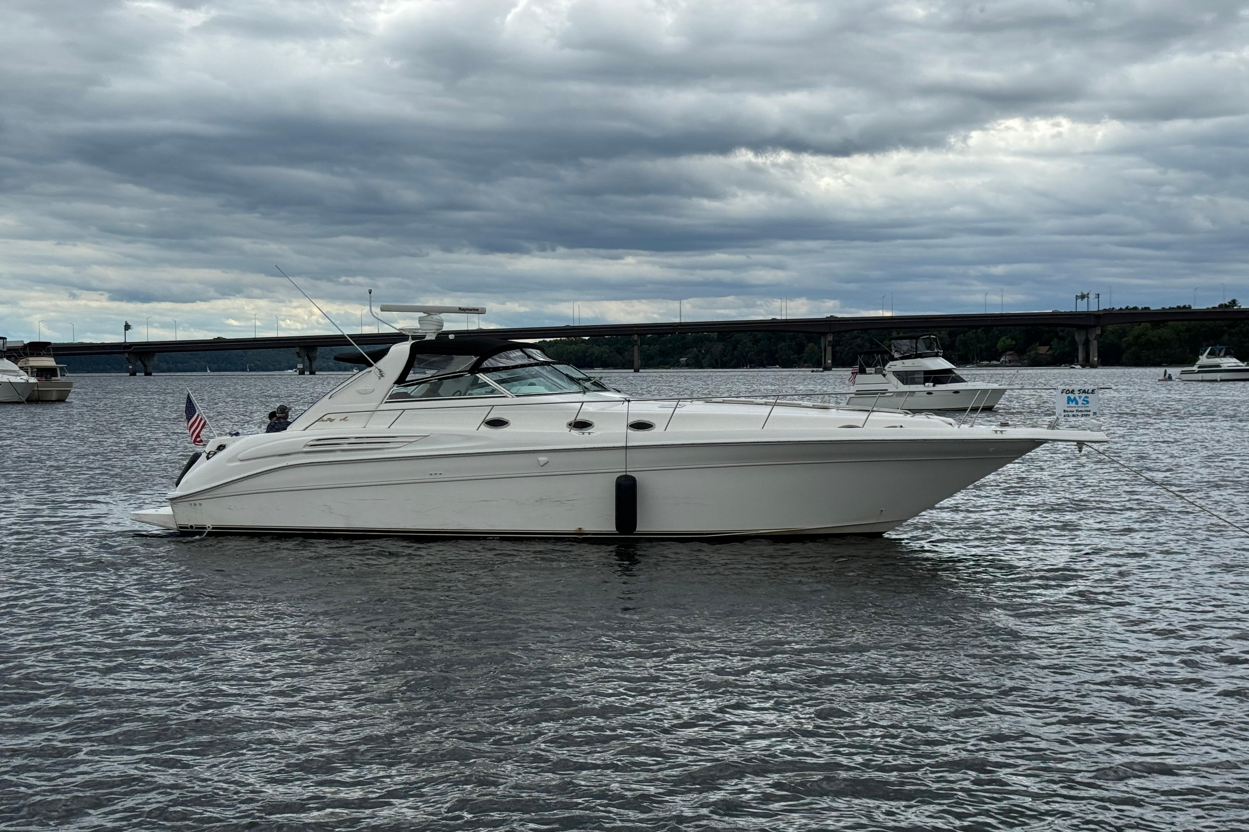 Sea Ray 450 Sundancer 1997 Sea Ray 450 Sundancer yacht on water, cloudy sky, bridge in background.