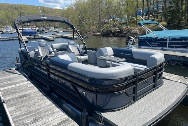 Bennington 22SSR 2025 Bennington 22SSR pontoon boat docked on a serene lake.