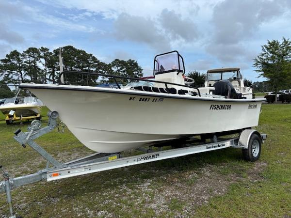 May-Craft 1800 Skiff 2021 May-Craft 1800 Skiff boat on trailer, labeled "FISHINATOR," parked on grass.