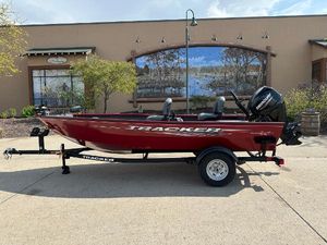 Tracker Super Guide V-16 T 2025 Tracker Super Guide V-16 T boat, red, on trailer, parked outdoors.