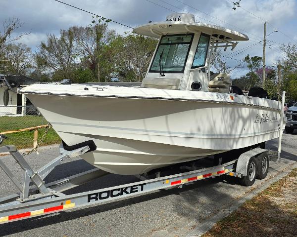 Boston Whaler 250 Outrage 2018 Boston Whaler 250 Outrage boat on a trailer, parked on a street.