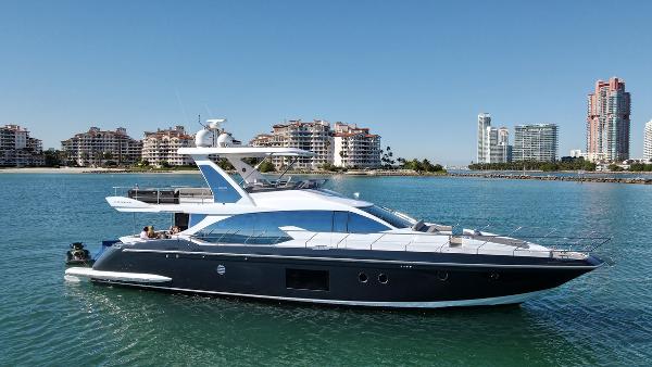 Azimut 66 2018 Azimut 66 yacht cruising near coastal cityscape.