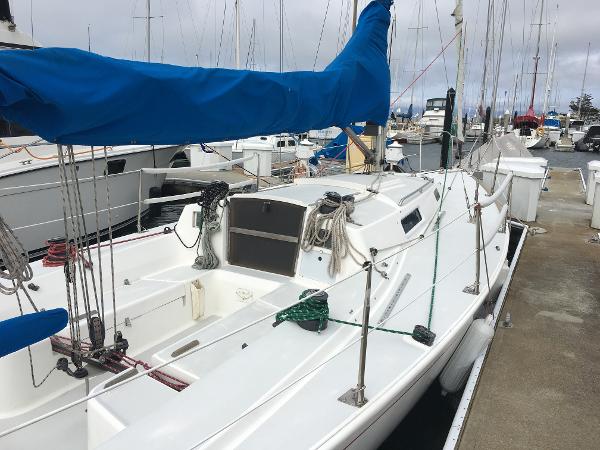 J Boats J/105 1992 J Boats J 105 sailboat docked, featuring blue sail cover and clean white deck.