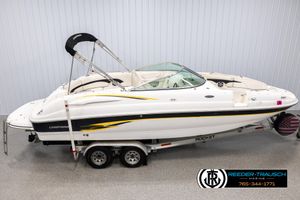 Chaparral Sunesta 243 2002 Chaparral 243 Sunesta boat on trailer in showroom, side view.