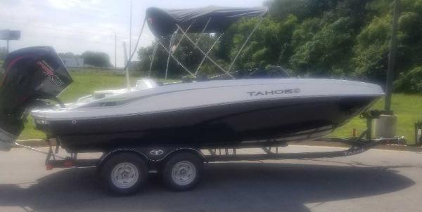Tahoe T21 2024 Tahoe T21 boat on trailer, parked outdoors.