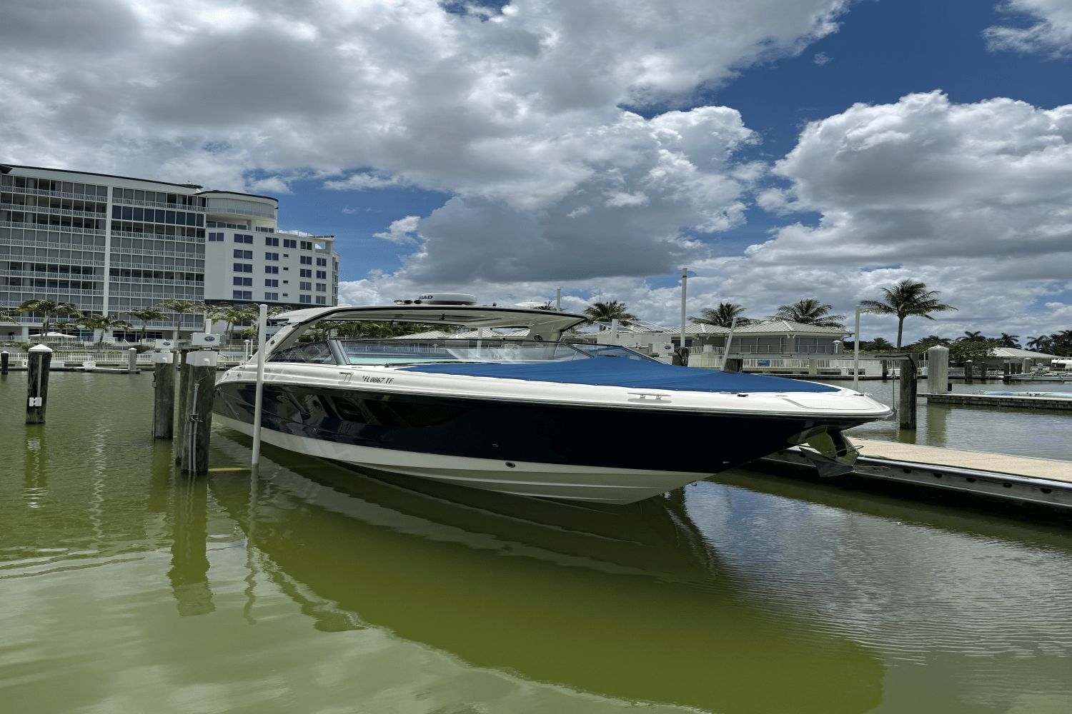 Sea Ray 400 SLX-OB 2022 Sea Ray 400 SLX-OB boat docked at marina under cloudy sky.