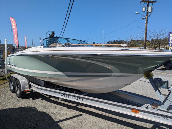Chris-Craft Corsair 25 2008 Chris-Craft Corsair 25 boat on trailer, parked outdoors under clear blue sky.