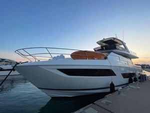 Prestige 690 Luxury 2023 Prestige 690 yacht docked at sunset, showcasing sleek design and elegance.