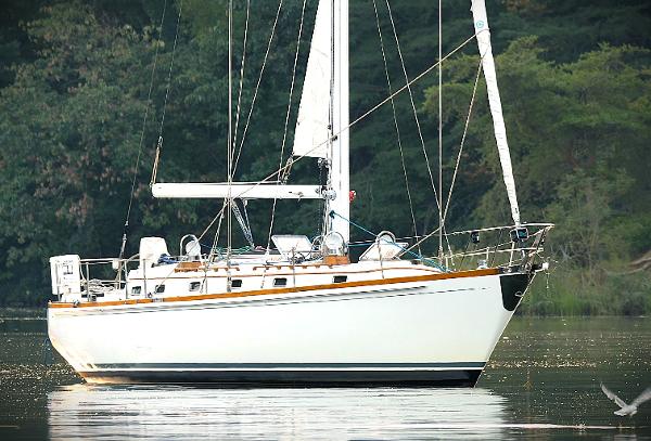 Little Harbor 44 1983 Little Harbor 44 sailboat on calm water, surrounded by lush greenery.