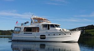 Beneteau Swift Trawler 52 2011 Beneteau Swift Trawler 52 yacht on calm water, clear sky background.