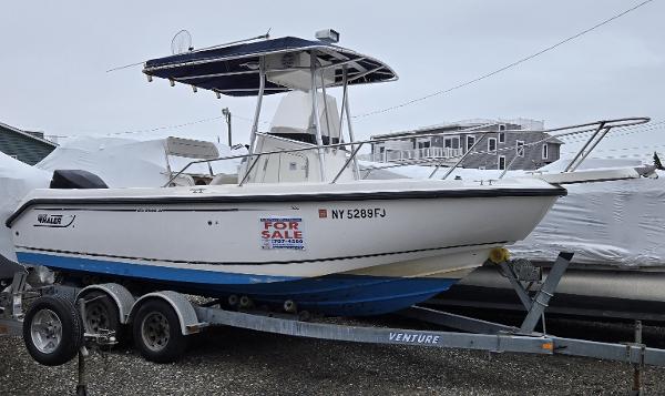 Boston Whaler 210 Outrage 2001 Boston Whaler 210 Outrage boat on trailer, for sale sign visible.