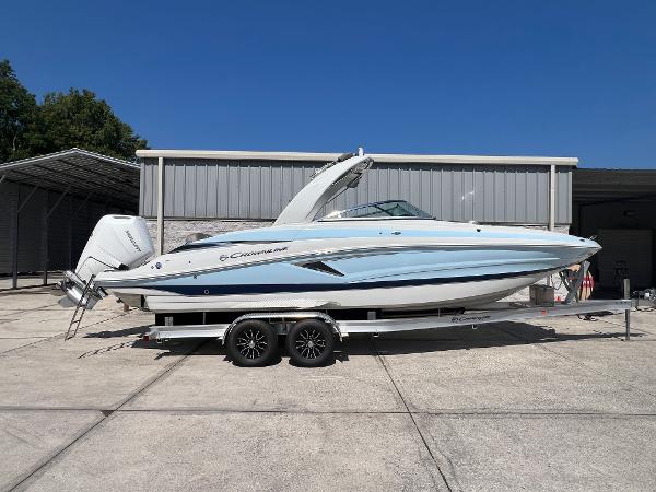 Crownline Eclipse E290 XS 2024 Crownline Eclipse E290 XS boat on a trailer in front of a storage building.
