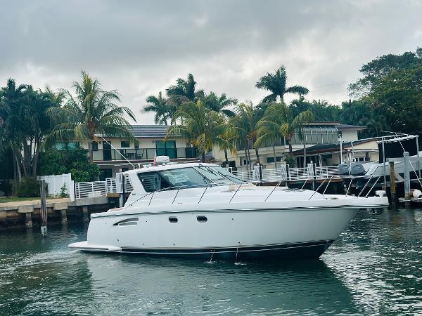 Tiara Yachts 3600 Sovran 2005 Tiara Yachts 3600 Sovran cruising near waterfront homes with palm trees.