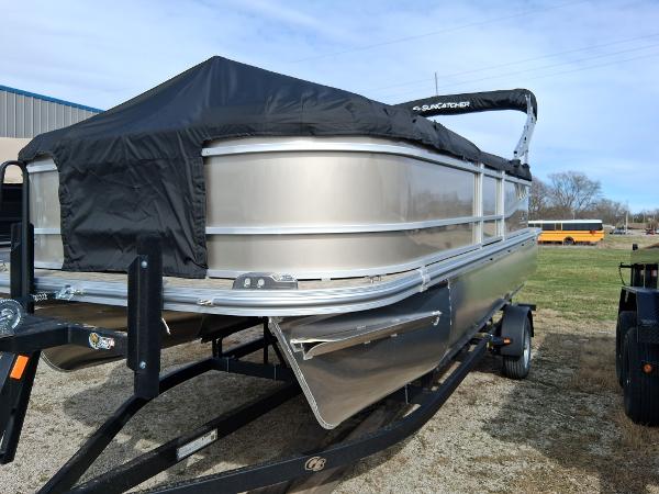 SunCatcher Select 20RC 2025 SunCatcher Select 20RC pontoon boat with cover on trailer, parked outdoors.