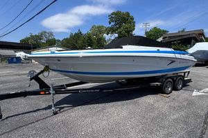 Crownline 240 SS 2023 Crownline 240 SS boat on trailer in parking lot, sunny day.