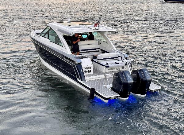 Formula 380 Super Sport Crossover OB 2024 Formula 380 Super Sport Crossover OB boat on water, featuring dual outboard engines.