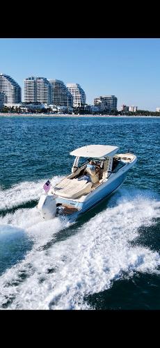 Chris-Craft Sportster 28 2025 Chris-Craft Sportster 28 cruising on ocean near city skyline.