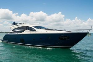 Pershing 82 2012 Pershing Sport Boat Planning on calm sea under blue sky.