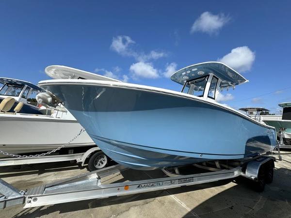 Sportsman Open 232 2025 Sportsman Open 232 boat on trailer under clear blue sky.