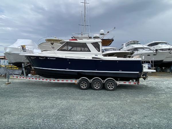 Cutwater C-28 2017 Cutwater C-28 boat on a trailer, surrounded by other boats in a marina.