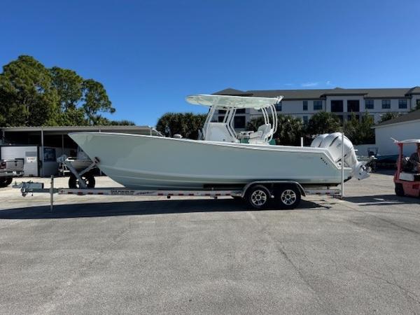 Pair Customs 28 Center Console 2025 Pair Customs 28 Center Console boat on trailer, parked outdoors under clear sky.