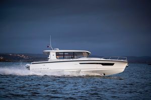 Nimbus C 12 2025 Nimbus C 12 boat cruising on open water under a cloudy sky.
