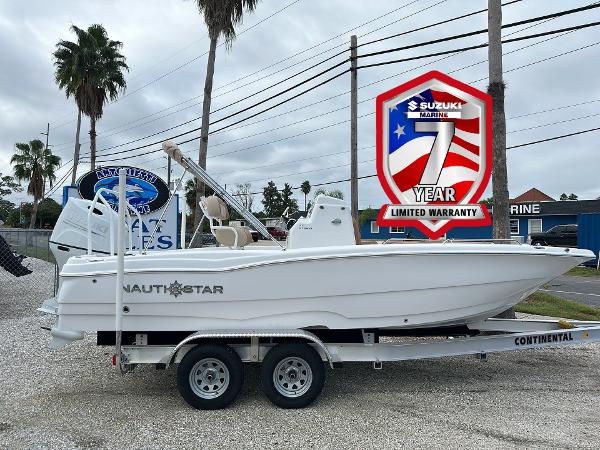 NauticStar 211 Hybrid 2024 NauticStar 211 Hybrid boat on trailer, featuring Suzuki 7-year limited warranty badge.