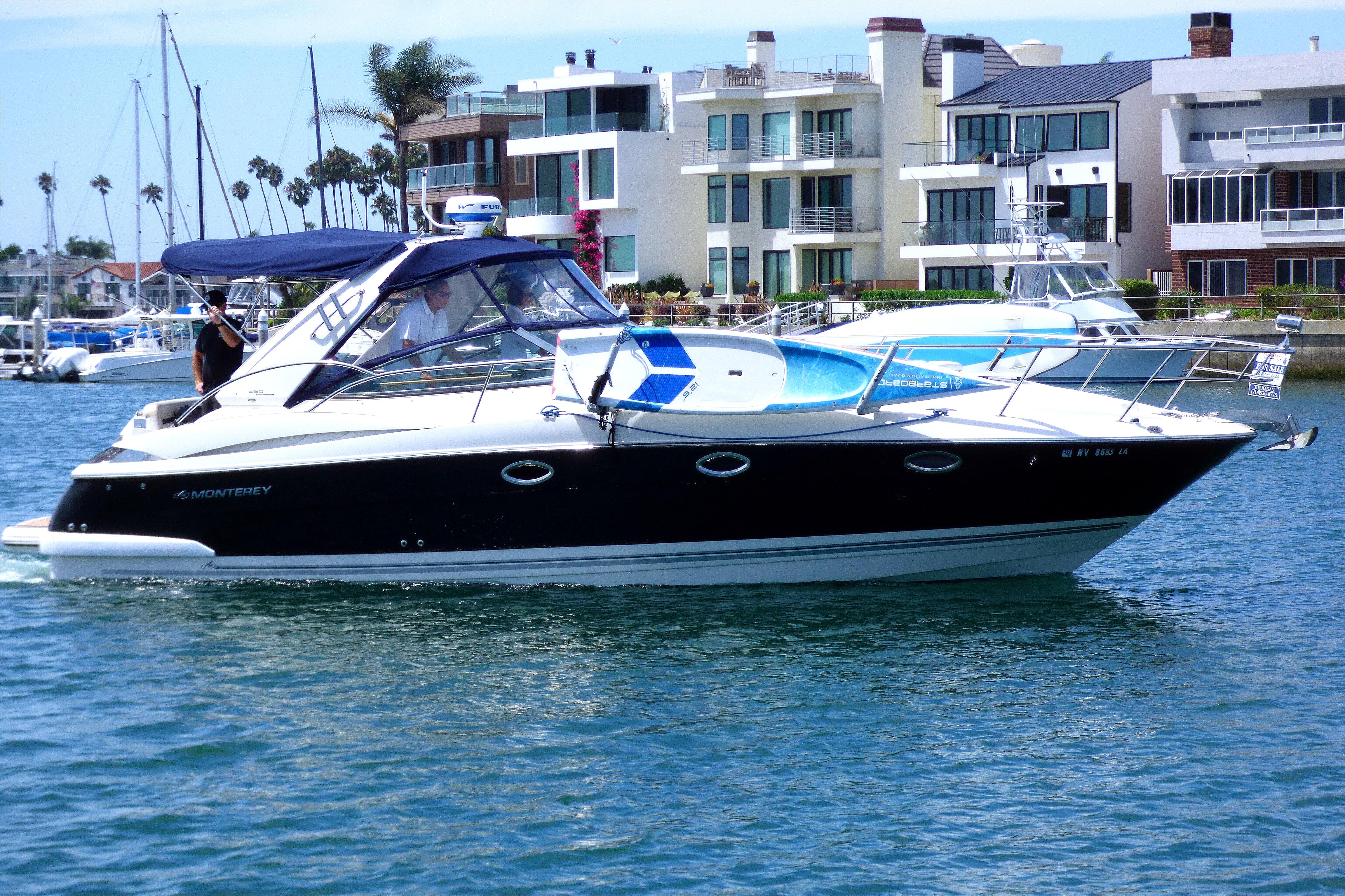 Monterey 350 Sport Yacht 2008 Monterey 350 Sport Yacht cruising in a marina with modern waterfront buildings.