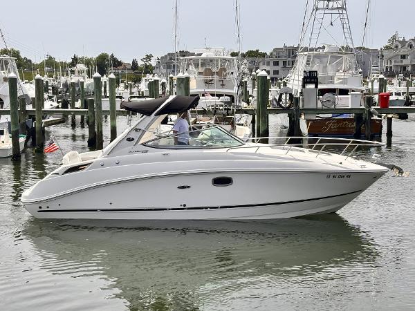 Sea Ray 280 Sundancer 2010 Sea Ray 280 Sundancer boat docked in marina, calm water, sunny day.