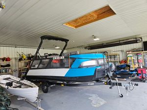 Sea-Doo Switch Cruise 21 2023 Sea-Doo Switch Cruise 21 in a garage, showcasing its sleek design and vibrant colors.