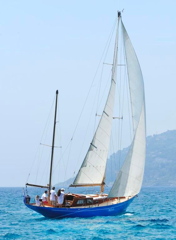 Sangermani Yawl 1964 Sangermani Yawl sailing on clear blue waters with crew onboard.