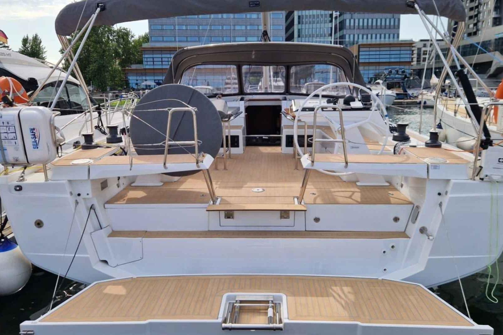 Hanse 460 2023 Hanse 460 yacht with spacious deck and modern design in marina setting.
