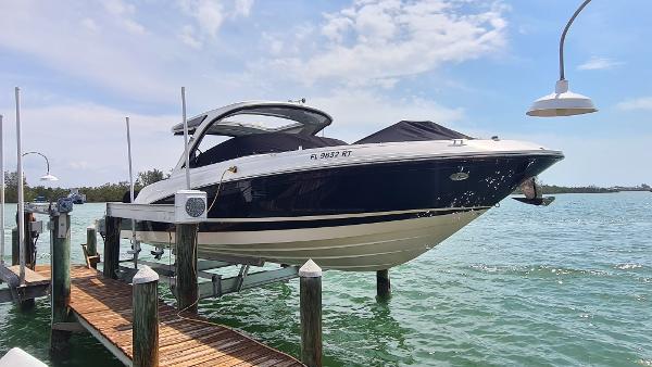 Sea Ray SLX 350 Outboard 2017 Sea Ray SLX 350 OB boat docked on a lift over clear water.