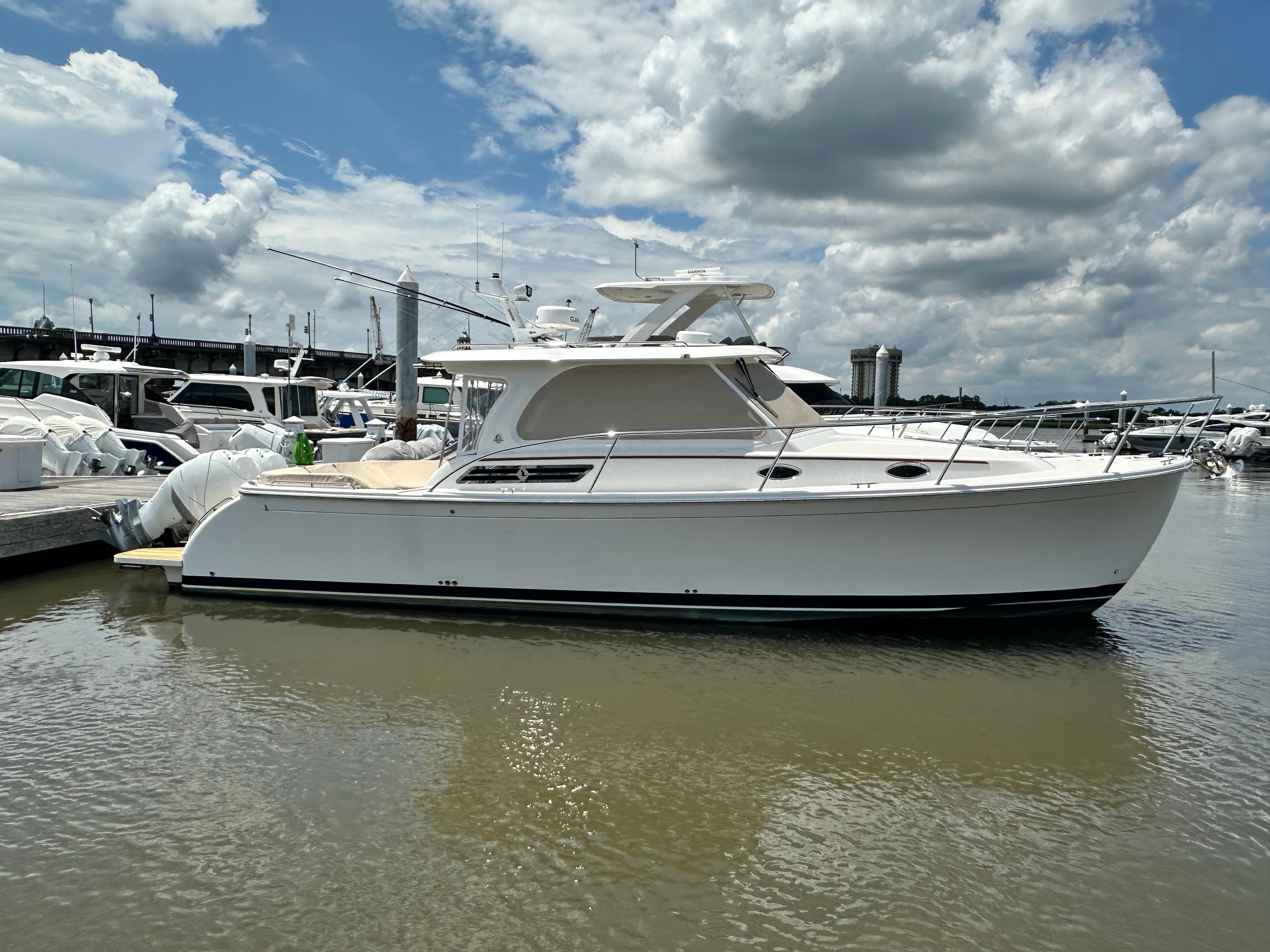 Back Cove 34O 2022 Back Cove 34O yacht docked at marina under cloudy sky.