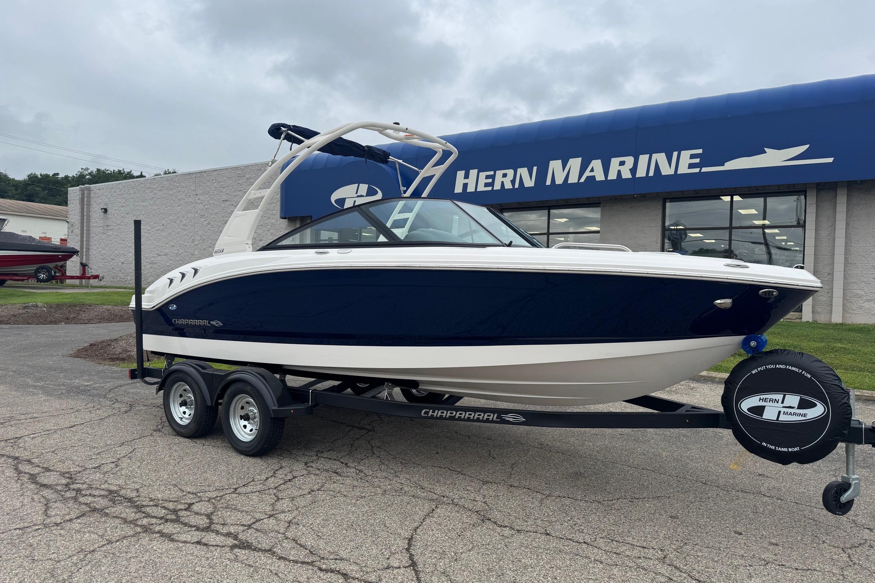Chaparral 21 SSi 2026 Chaparral 21 SSi boat on trailer at Hern Marine dealership.