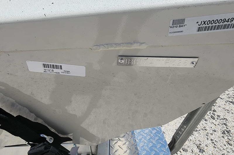Xpress H210B 2026 Xpress H210B boat hull with identification plates and barcodes.