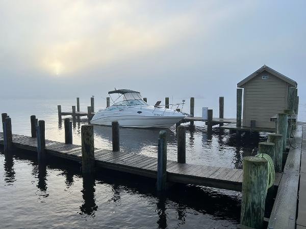Rinker 266 Fiesta Vee 1997 Rinker 266 Fiesta Vee boat docked at a serene, misty marina.
