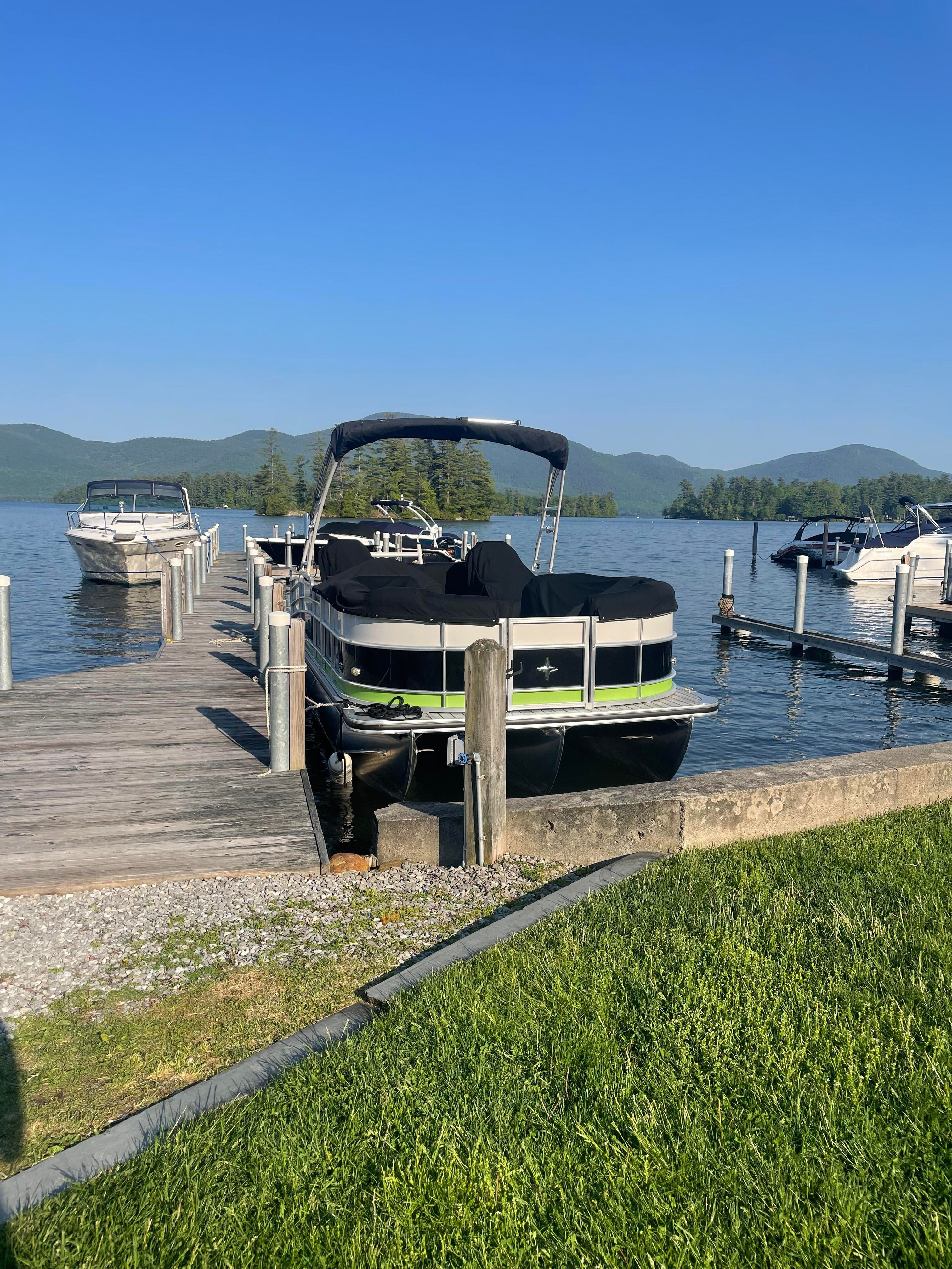Berkshire Super Sport STS 3.0 2019 Berkshire Super Sport STS 3.0 pontoon boat docked on a serene lake.