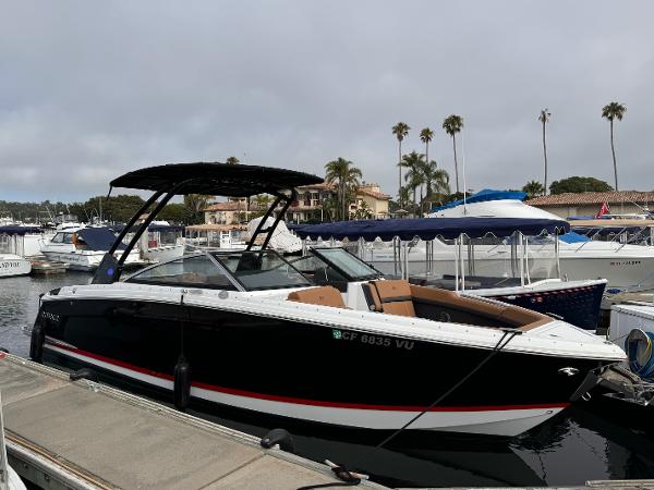 Cobalt R8 2022 Cobalt R8 boat docked in a marina with palm trees in the background.